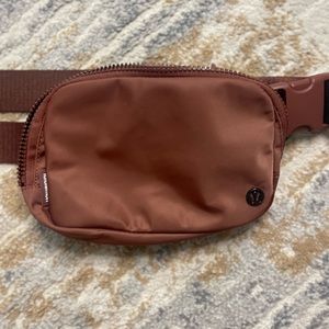 LULULEMON hip bag in ancient copper. Like new!! With new style extended strap.